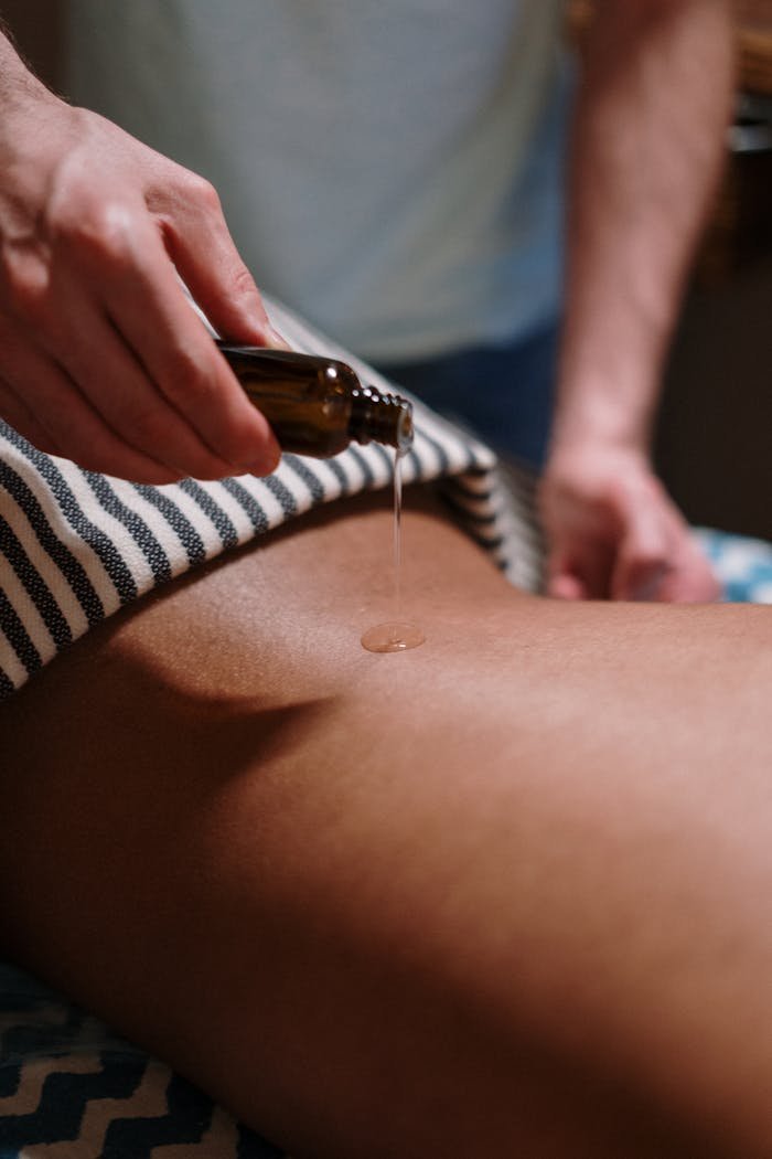 Experience tranquility with a soothing oil massage in a serene spa environment.